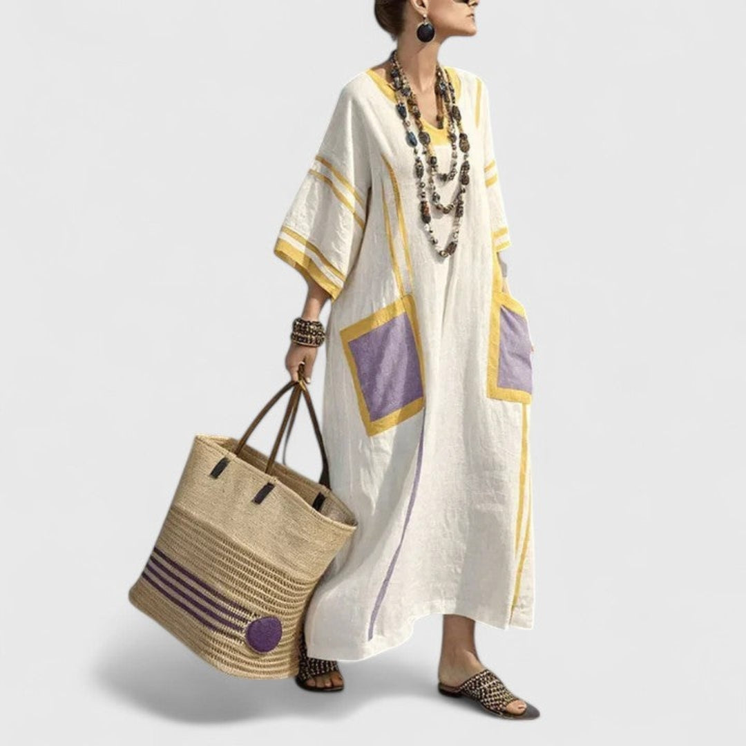 Full-length view of a women's boho striped maxi dress. Flowy V-neck kaftan with pockets, great for summer comfort.