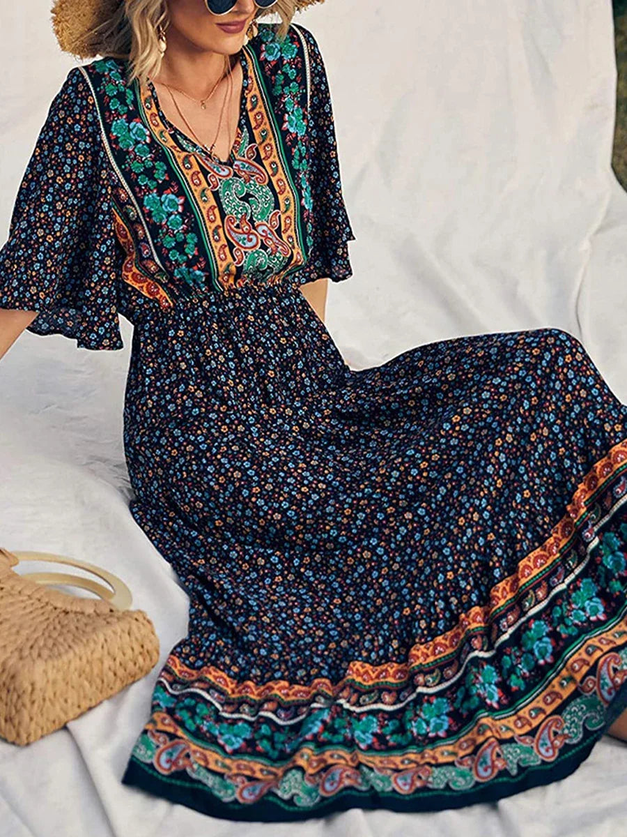 Elegant women's boho summer dress, vibrant printed V-neck, short sleeve, flowing for vacation.