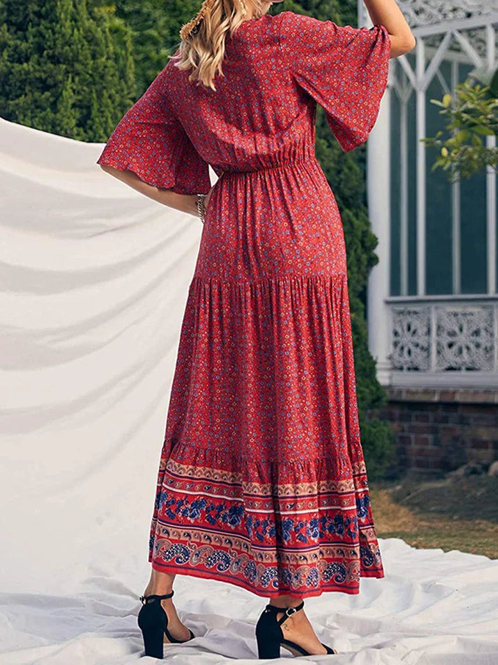Flowing women's boho summer dress, elegant V-neck, short sleeve, vibrant print, perfect vacation wear.