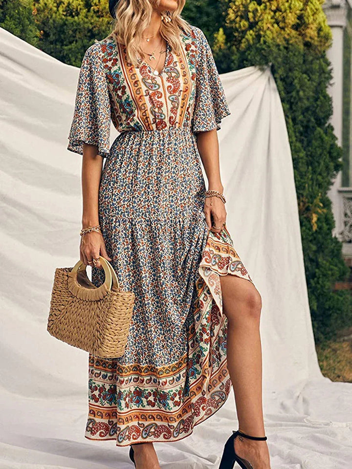 Women's elegant boho summer dress, short sleeve V-neck, colorful print, flowing vacation fashion.