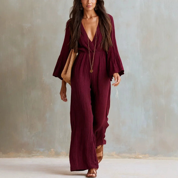 Chic women's wide leg boho jumpsuit with a flattering deep V-neck and flowy flare sleeves, ideal for vacation wear.