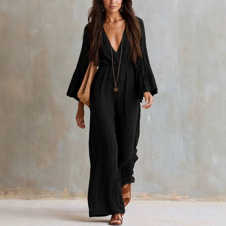 Fashionable women's boho jumpsuit with wide legs, a deep V-neckline, and elegant flare sleeves for a comfortable look.