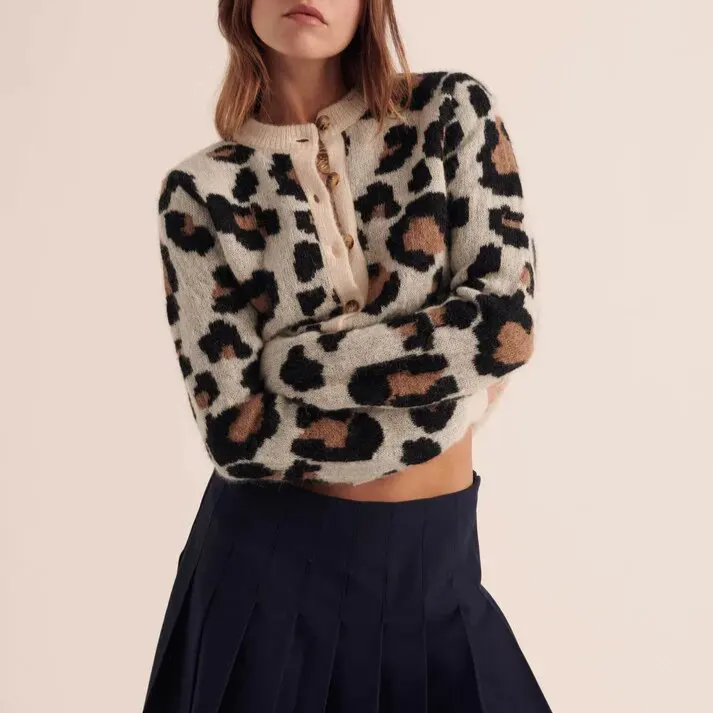 Comfortable women's knit cardigan, features eye-catching leopard print, cozy fabric, and stylish striped cuffs.