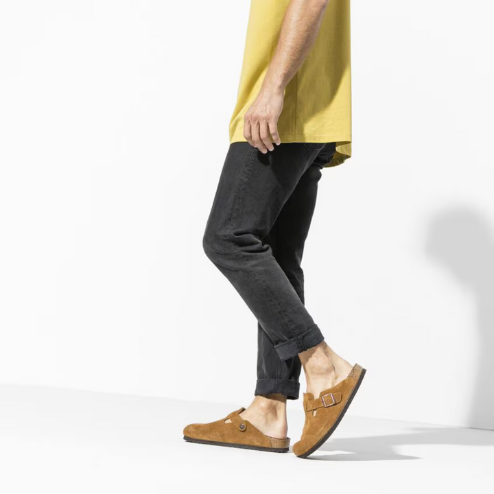 Women's feet wearing stylish taupe Boston clogs, showcasing their casual comfort and classic design for daily wear.