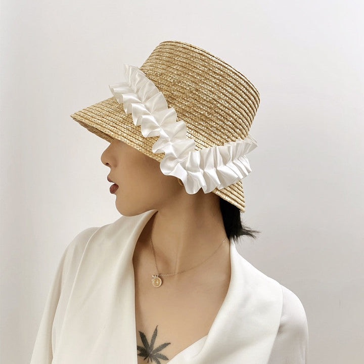 Women's braided straw bucket hat with blue & white stripes, perfect for summer beachwear