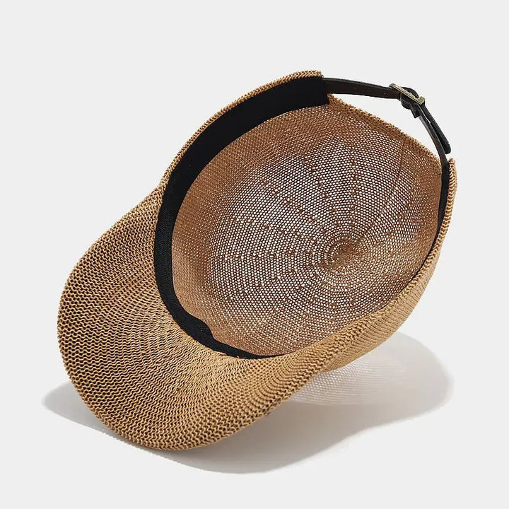 Close-up of a women's braided summer hat with a wide brim, showcasing texture.