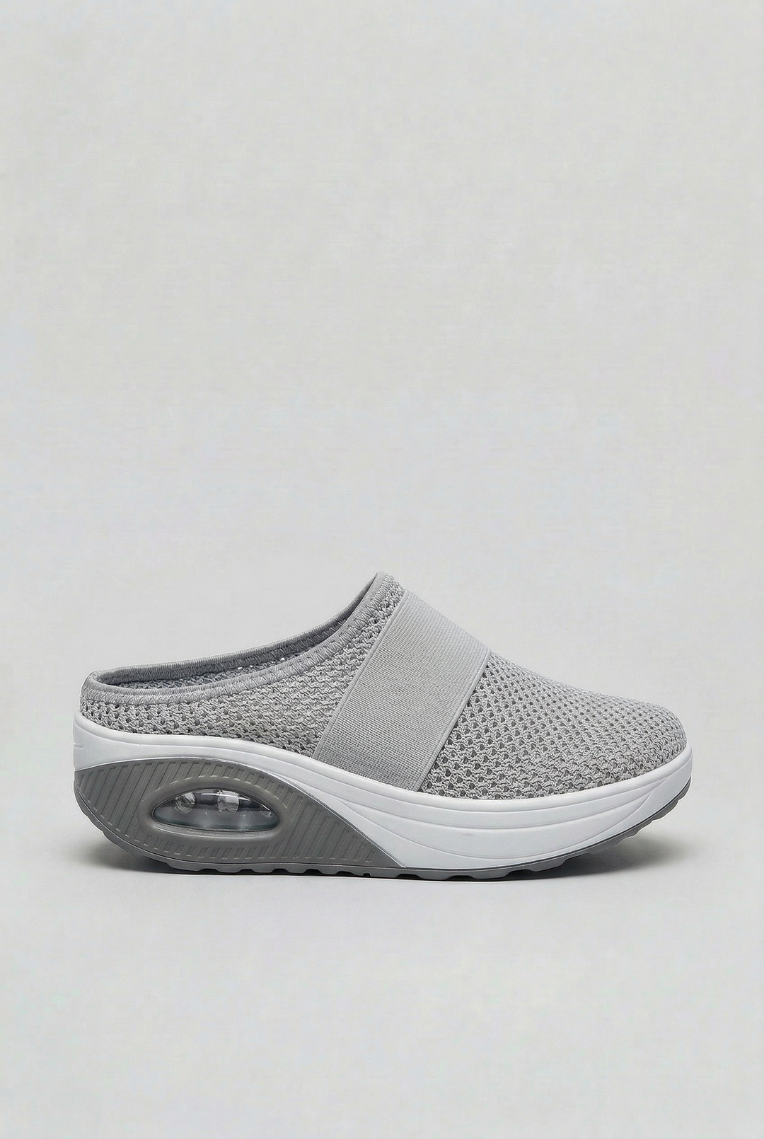 Side profile of women's easy-wear mules with a visible air cushion sole, offering modern casual style.