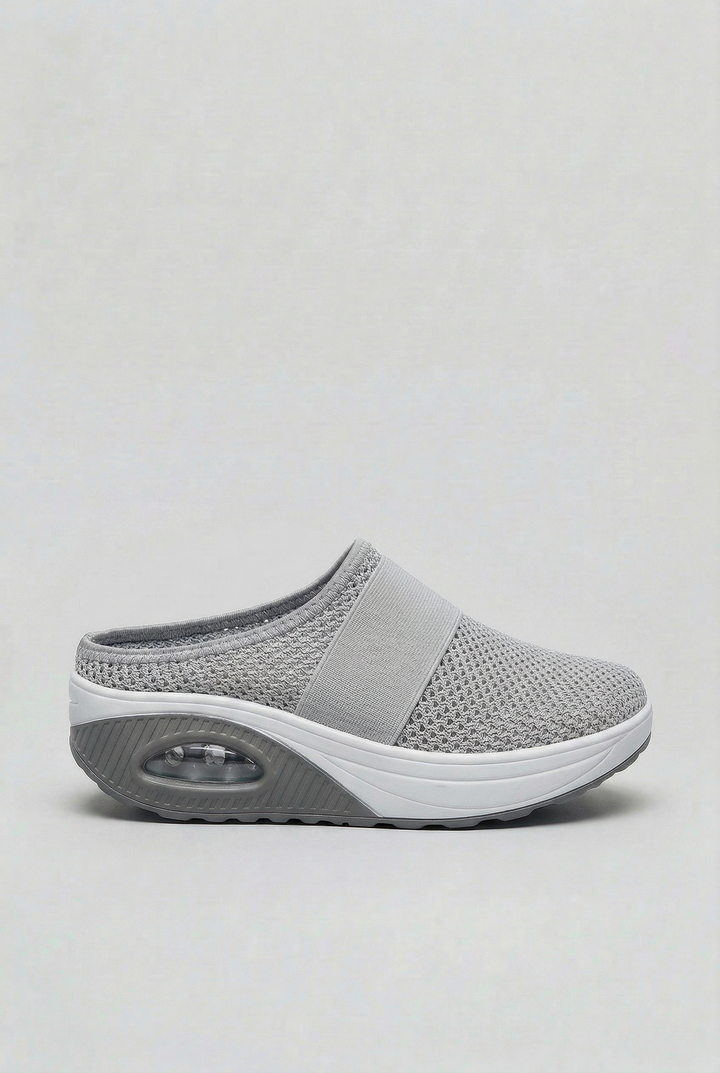 Side profile of women's easy-wear mules with a visible air cushion sole, offering modern casual style.
