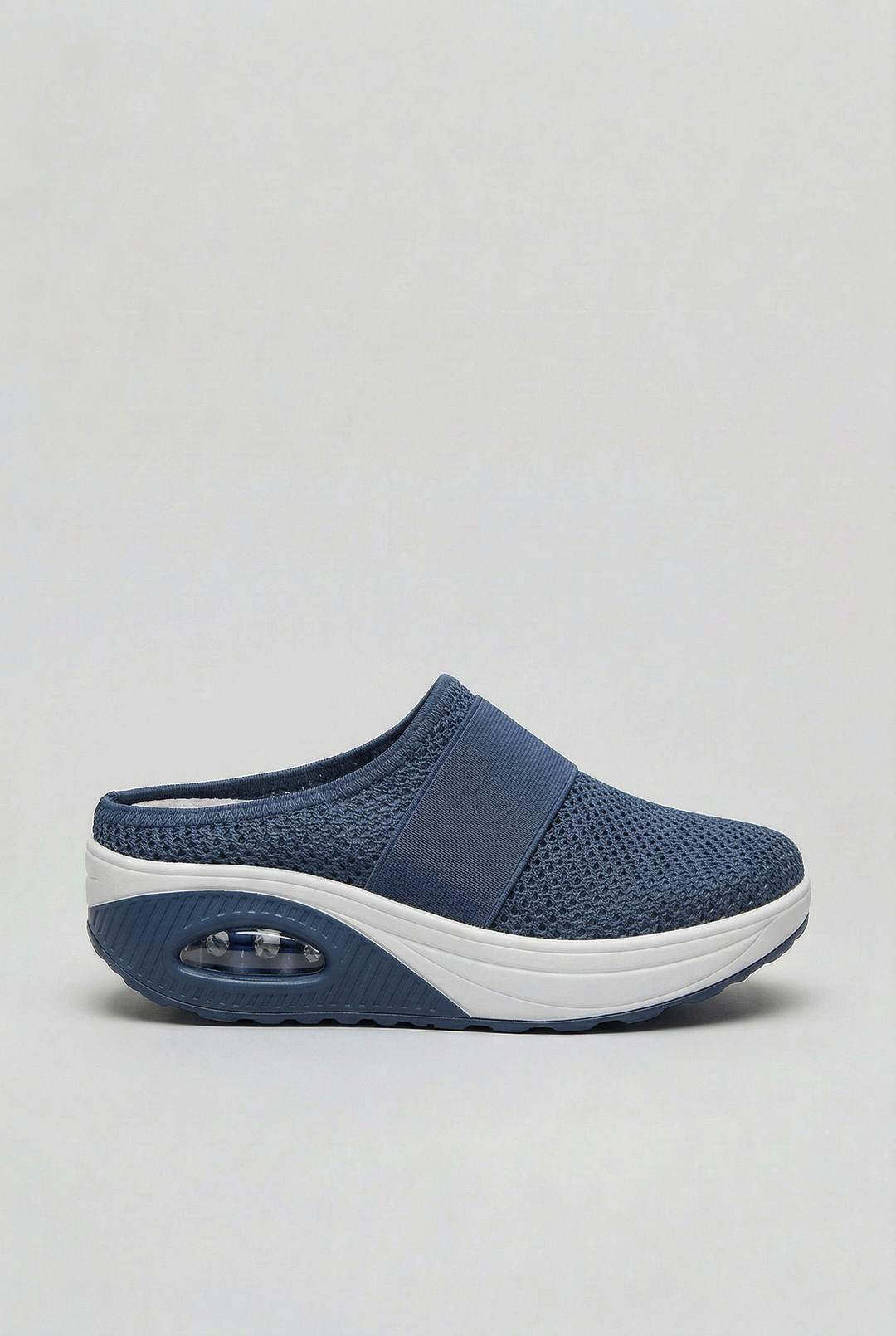 Women's casual summer mules on a patio, emphasizing their relaxed style and comfortable slip-on design.