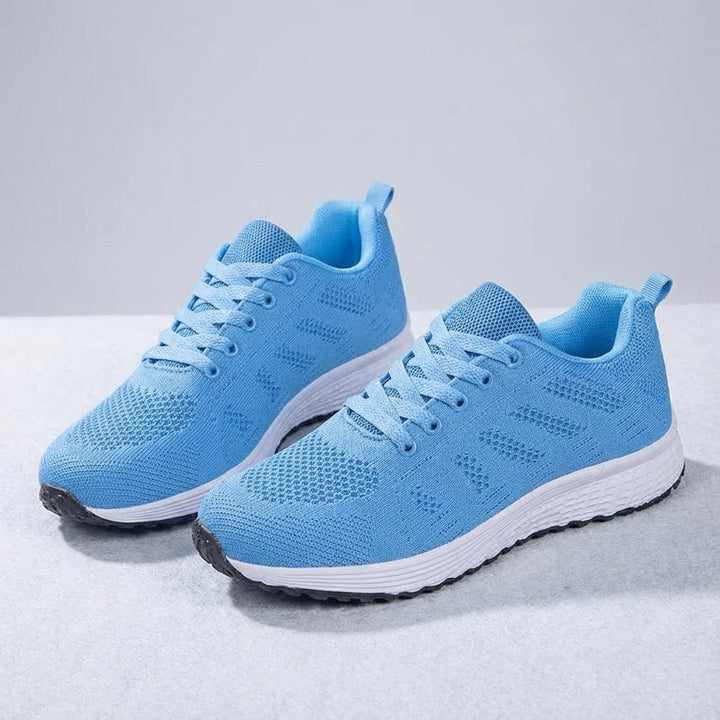 Close-up of knitted texture on women's sports shoes, emphasizing breathability