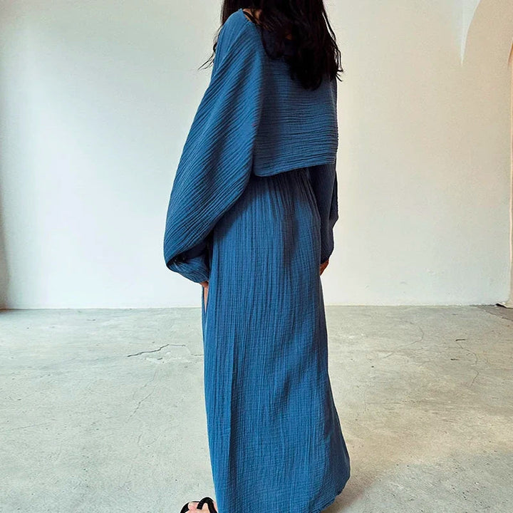 Breathable linen women's two-piece set, featuring a relaxed-fit cropped top and a stylish slit skirt.