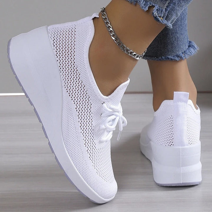 Women's comfortable platform wedge sneakers. Breathable material, elevated style, perfect for fashionable casual wear.