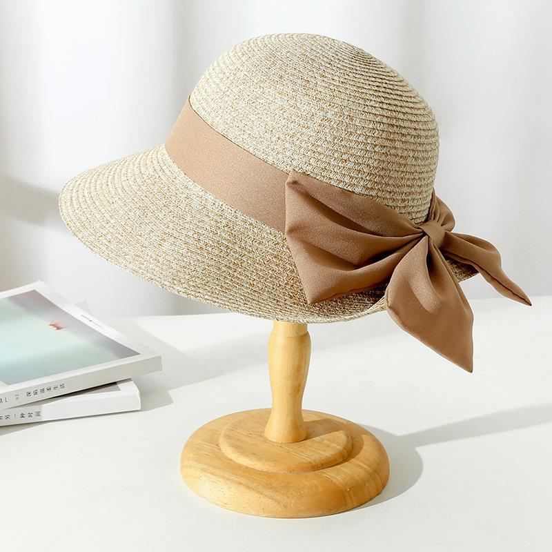 Fashionable Monica sun hat for women, featuring a breathable design and a chic bow, ideal for summer accessories.