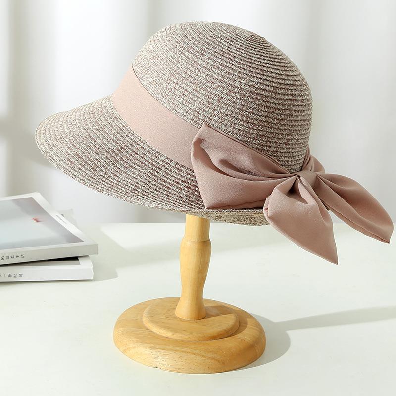 Elegant Monica women's sun hat, designed with breathable fabric and a sophisticated bow, great for beach wear.