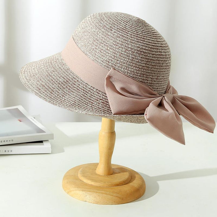 Elegant Monica women's sun hat, designed with breathable fabric and a sophisticated bow, great for beach wear.
