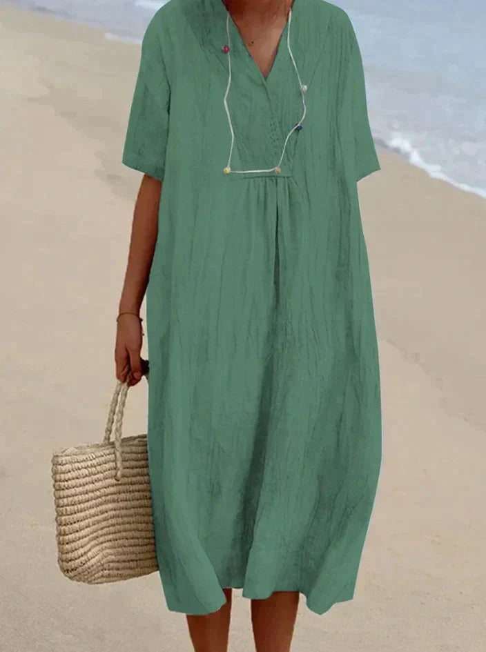 Versatile women's casual A-line dress featuring a breezy design, V-neck, and essential hidden pockets.
