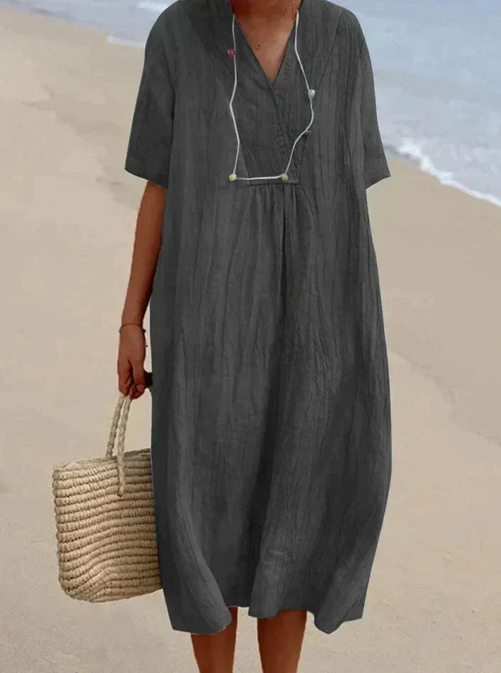 Lightweight women's summer A-line dress with a soft fabric, V-neckline, and convenient pockets for essentials.