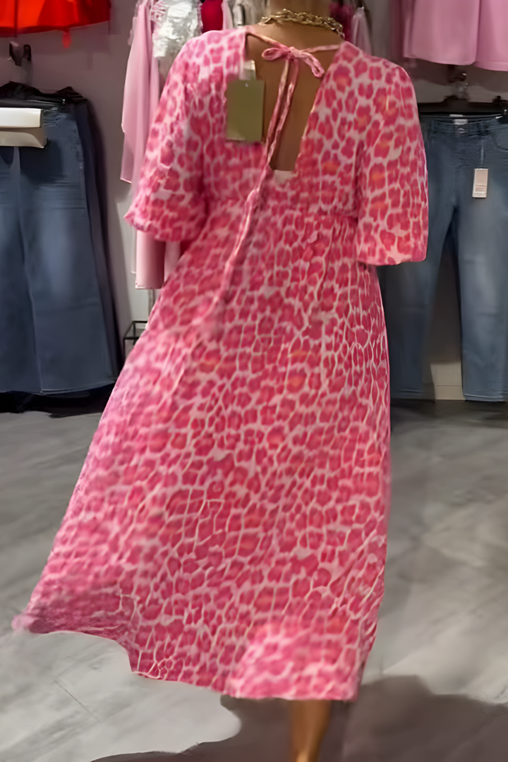V-neck women's midi day dress with delicate floral print and airy flutter sleeves for a breezy summer look.