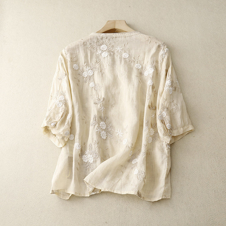 Relaxed fit women's floral embroidered blouse, a versatile tie-front long sleeve top for breezy spring & summer style.