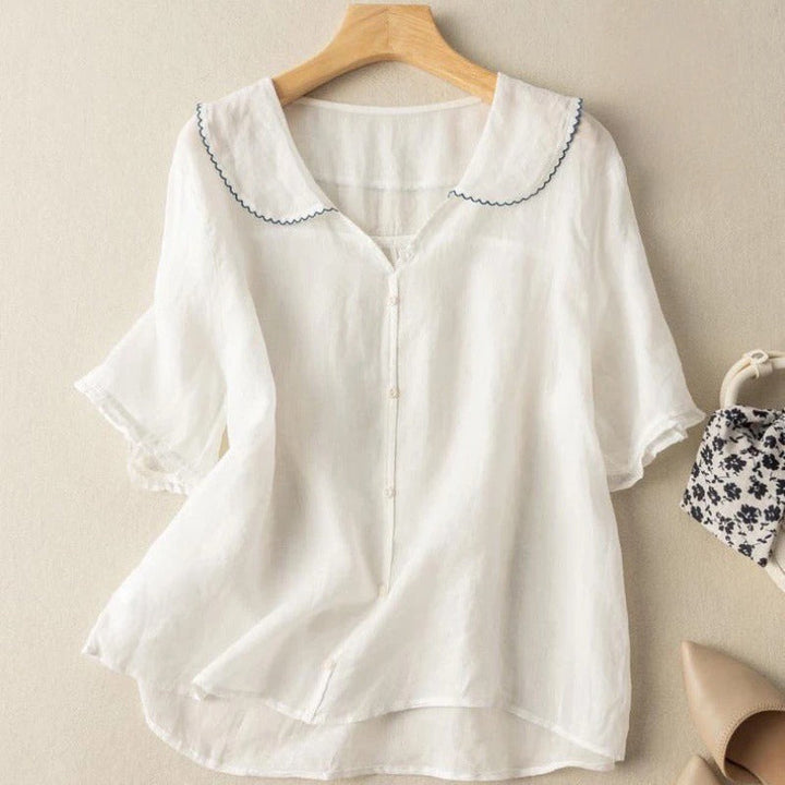 Relaxed fit women's breezy blouse with a stylish scallop collar. Effortless summer fashion for a comfortable, chic look.