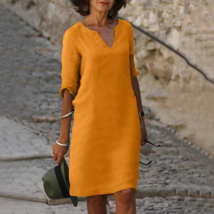 Fashionable women's sleeveless summer dress, featuring a flattering V-neck and midi length.