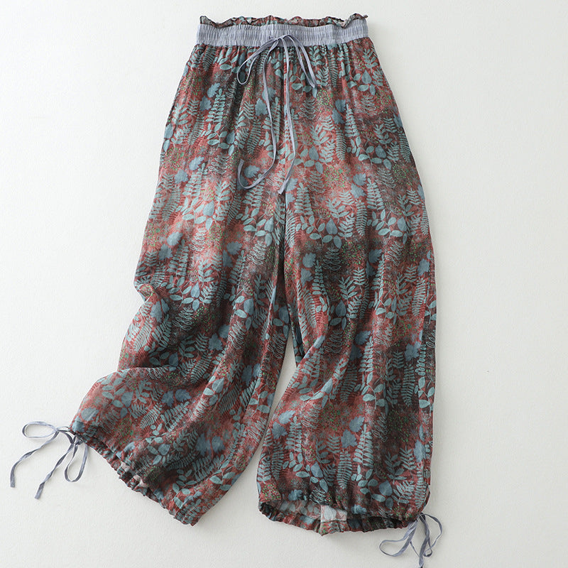 Women's breezy wide-leg comfort pants with a flowy fit, drawstring waist, and stylish leafy pattern for summer.