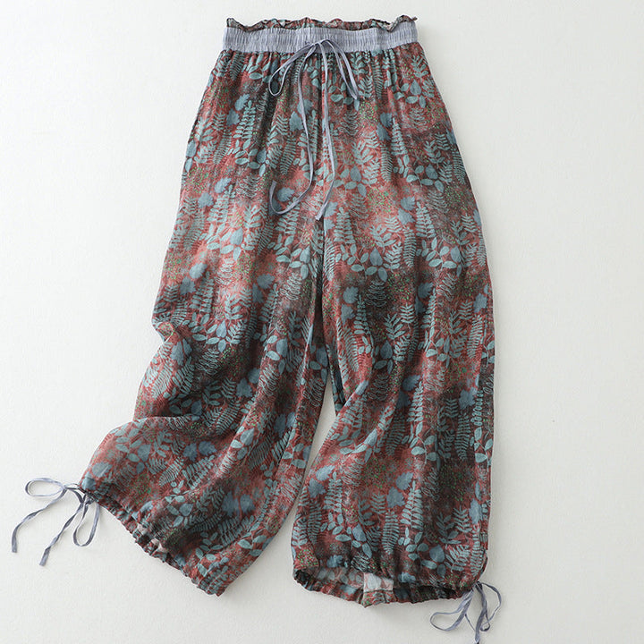 Women's breezy wide-leg comfort pants with a flowy fit, drawstring waist, and stylish leafy pattern for summer.
