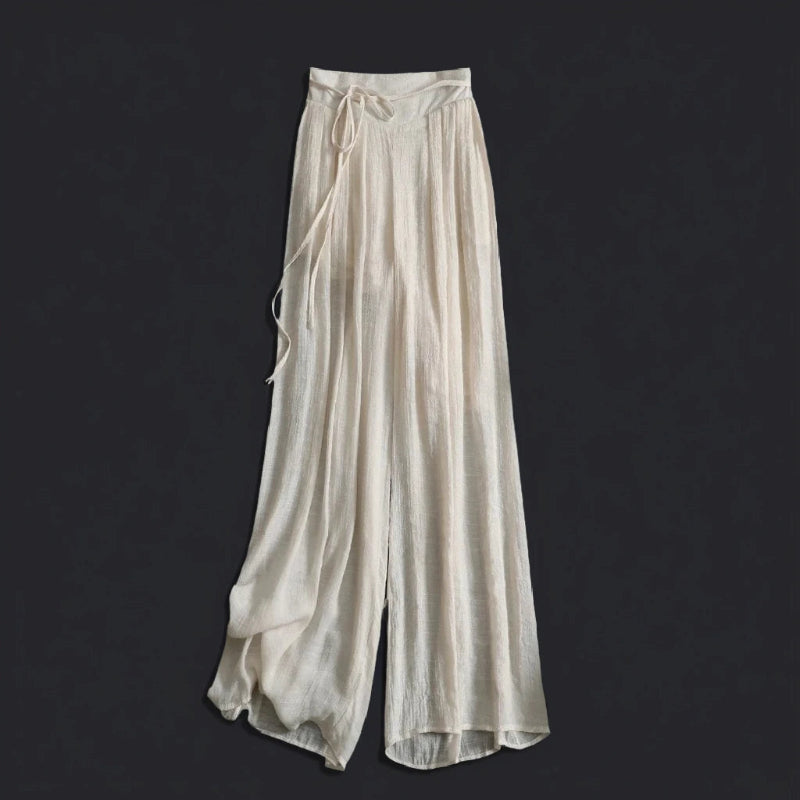 Flowy women's wide-leg summer trousers, ideal for beach, vacation, or relaxed elegant style.