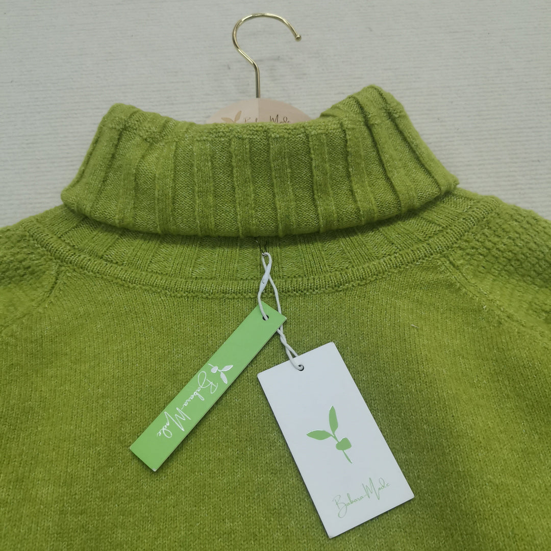 Fall fashion women's bright green oversized knitted sweater, with a flattering turtleneck collar.