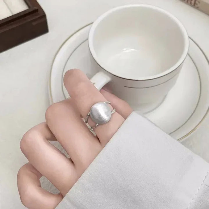 Minimalist women's sterling silver half dome ring with unique brushed finish. Stylish and modern jewelry.
