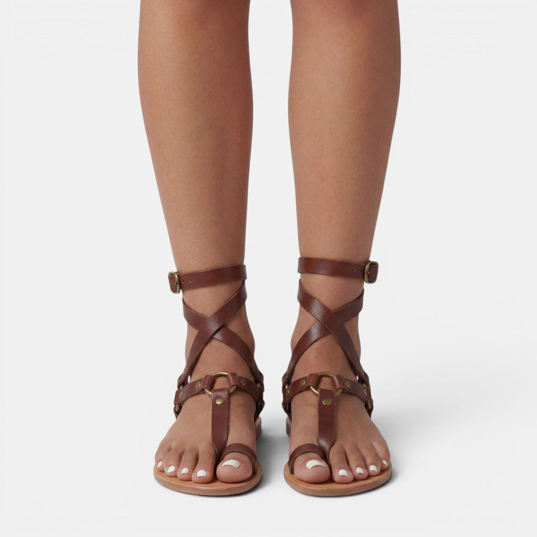 Chic women's flat sandals featuring exotic snake print and elegant buckles, perfect for casual summer fashion.