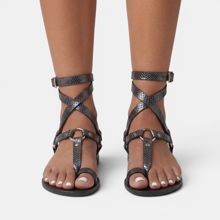 Exotic snake print women's flat sandals with stylish buckles & crossover straps, offering chic summer comfort.