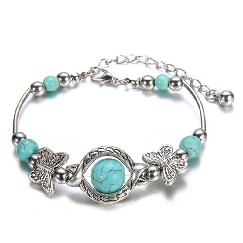Women's butterfly & turquoise beaded bracelet with silver accents, a delicate jewelry accessory.