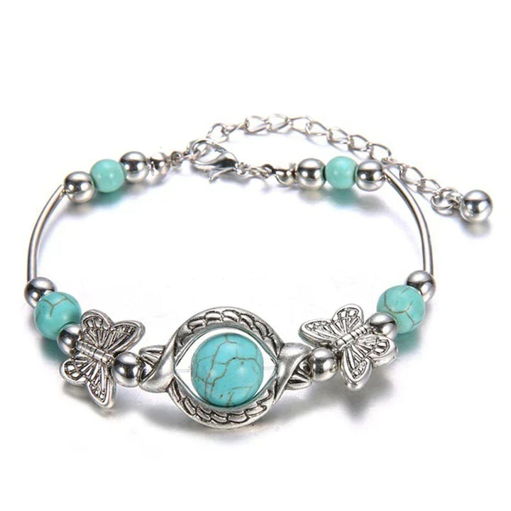 Women's butterfly & turquoise beaded bracelet with silver accents, a delicate jewelry accessory.