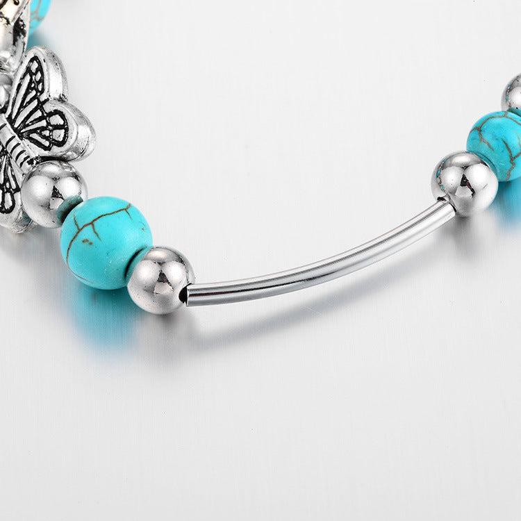 Chic women's butterfly & turquoise beaded bracelet, adjustable silver jewelry, a fashionable accessory.