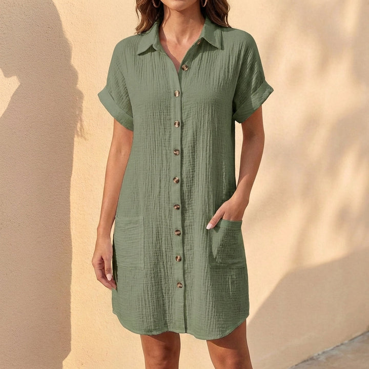 Women's button-front midi shirt dress with cuffed sleeves. Versatile, relaxed fit for summer or casual wear.