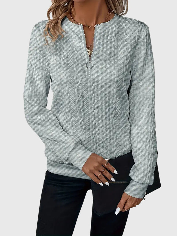 Women's cozy cable knit quarter-zip pullover, blending style & warmth for chilly days.