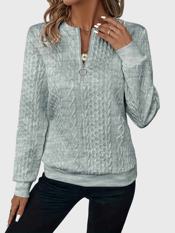 Classic cable knit women's quarter-zip sweater, a cozy and structured long-sleeve for fall/winter.