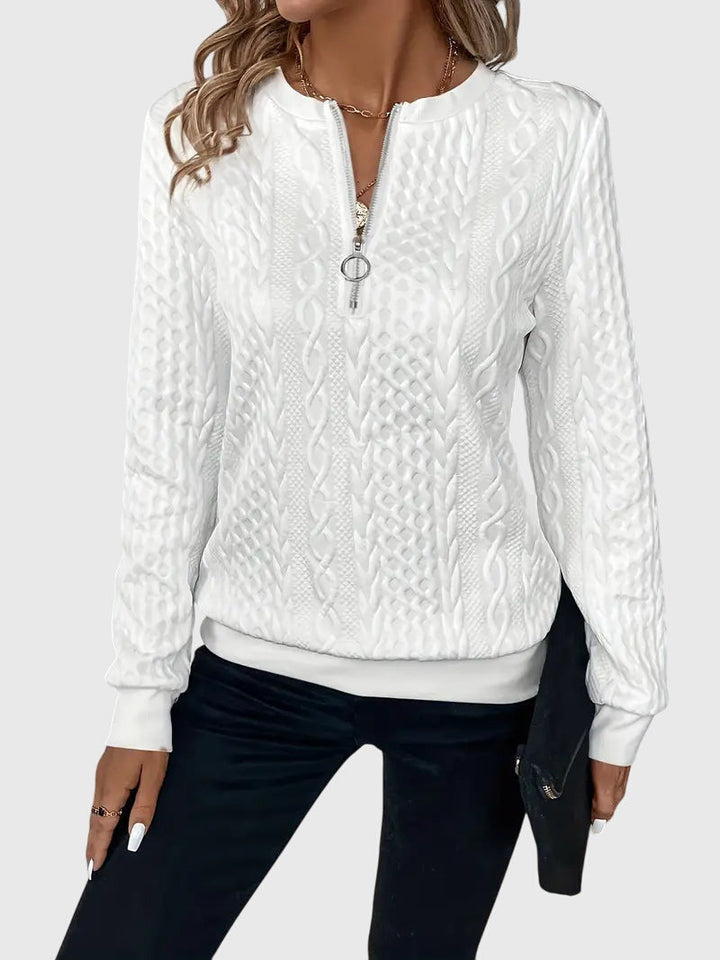 Soft women's cable knit quarter-zip sweater, providing ultimate comfort for relaxed everyday wear.
