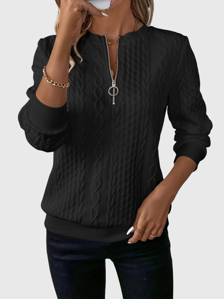 Comfortable women's cable knit sweater with stylish quarter-zip, great for fall fashion outfits.