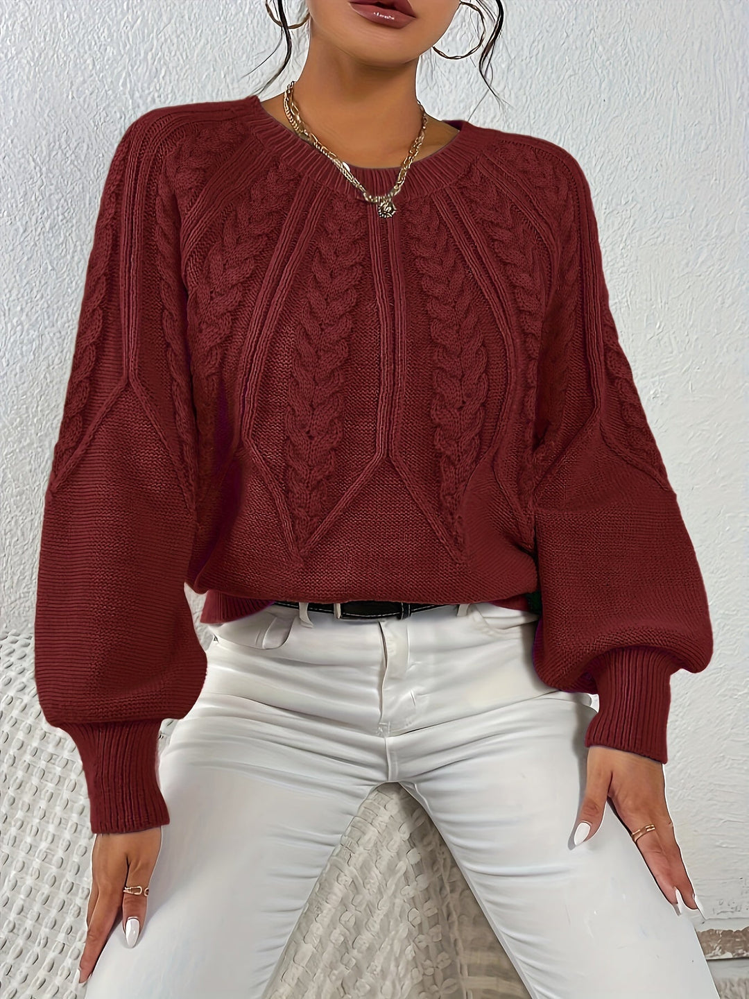 Women's relaxed fit cable knit sweater with chic lantern sleeves. Cozy and perfect for everyday wear.