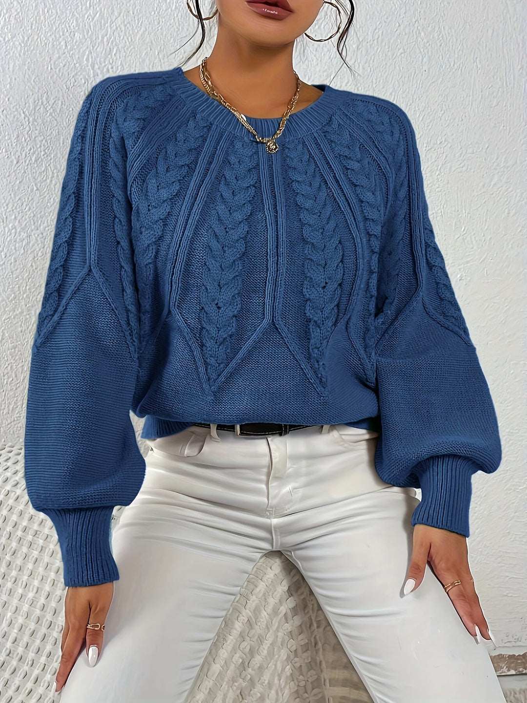 Elegant women's cable knit sweater, relaxed fit, graceful lantern sleeves. For sophisticated fall style.