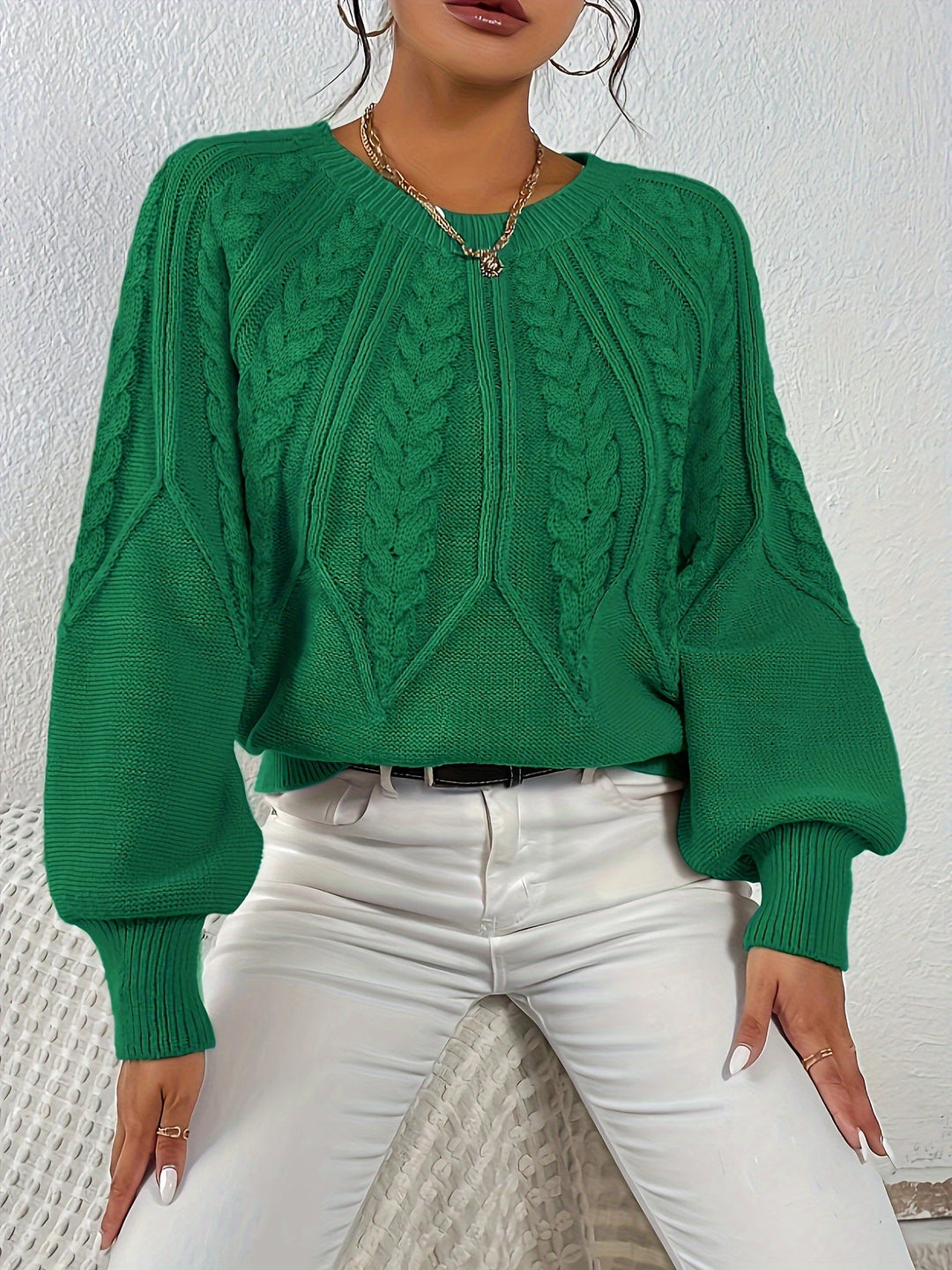 Relaxed fit women's cable knit sweater with charming lantern sleeves. Embrace cozy fall vibes.