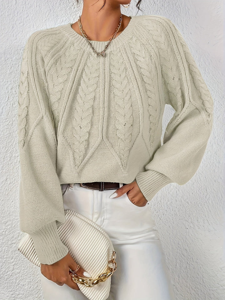 Warm women's cable knit sweater, relaxed fit, voluminous lantern sleeves. A winter fashion essential.