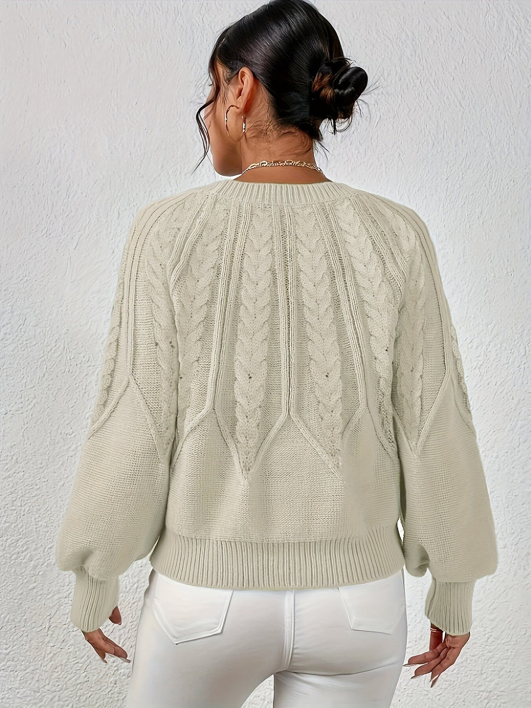 Comfortable women's oversized cable knit sweater with relaxed fit and stylish lantern sleeves.