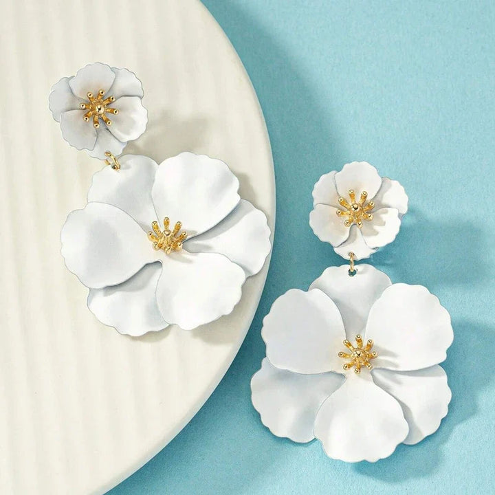 Close-up of gold plated cascading double flower earrings for women, intricate floral design.