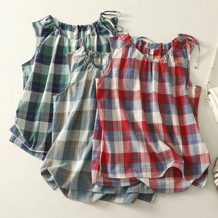Stylish women's sleeveless top, blue and white checkered pattern, with a delicate tie neck. Perfect for casual wear.