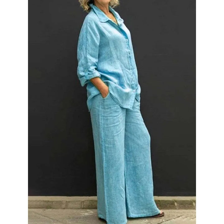 Stylish women's two piece outfit: versatile button-up top & flowy wide-leg trousers. Ideal resort wear.