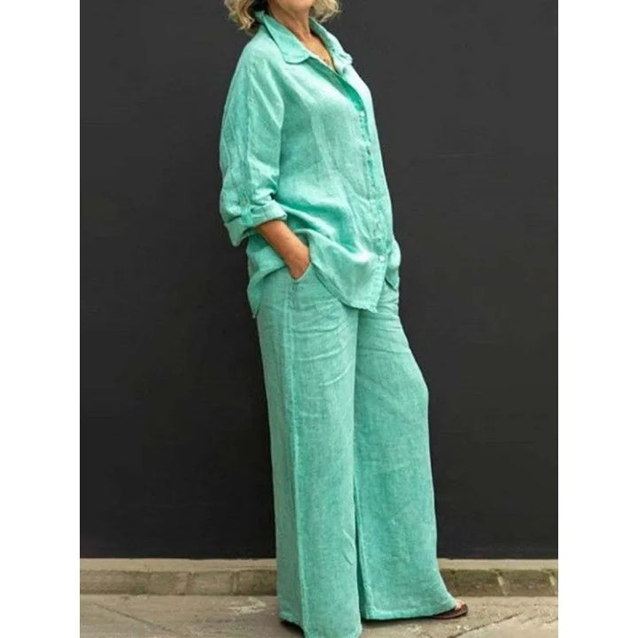 Detail of a women's button-up shirt from a two-piece set, featuring long sleeves & classic collar.