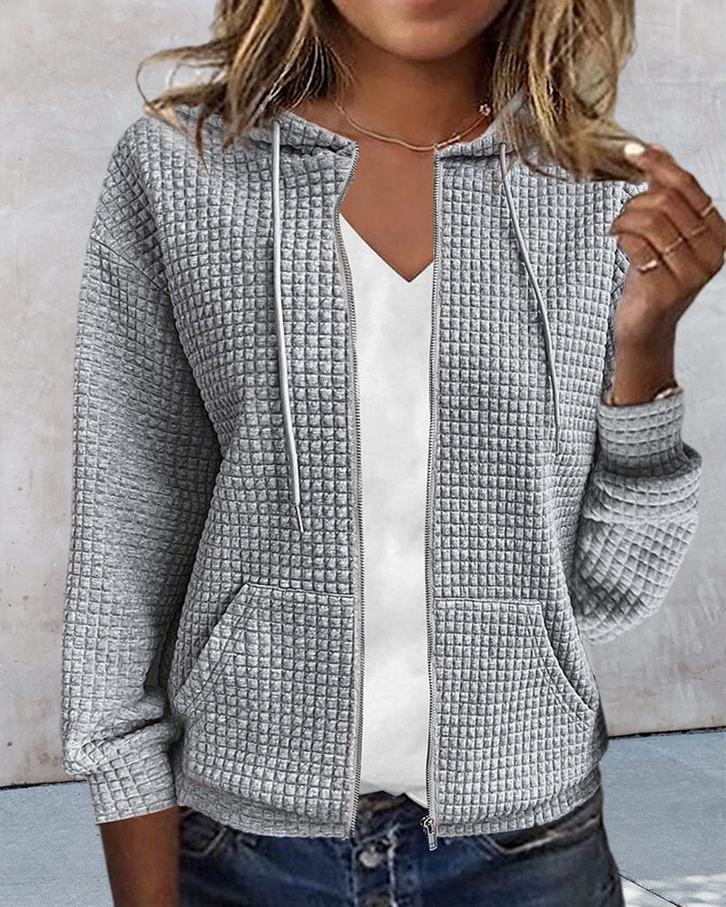 Soft women's sleeveless jacket featuring a zip closure, handy pockets, and stylish drawstrings for autumn wear.